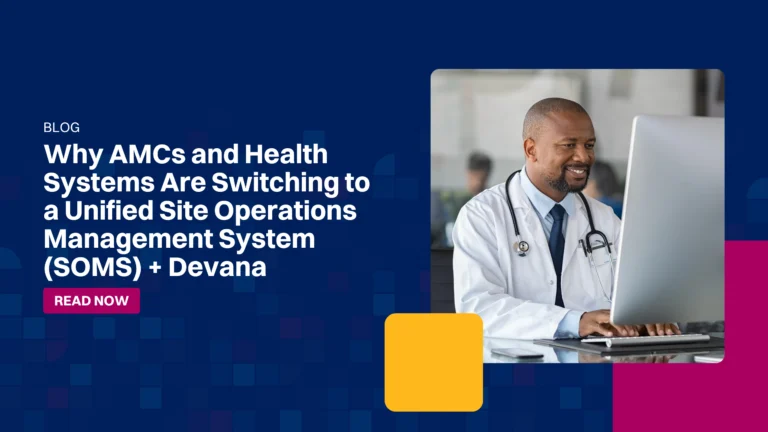 Smiling doctor sitting at desk looking at computer screen